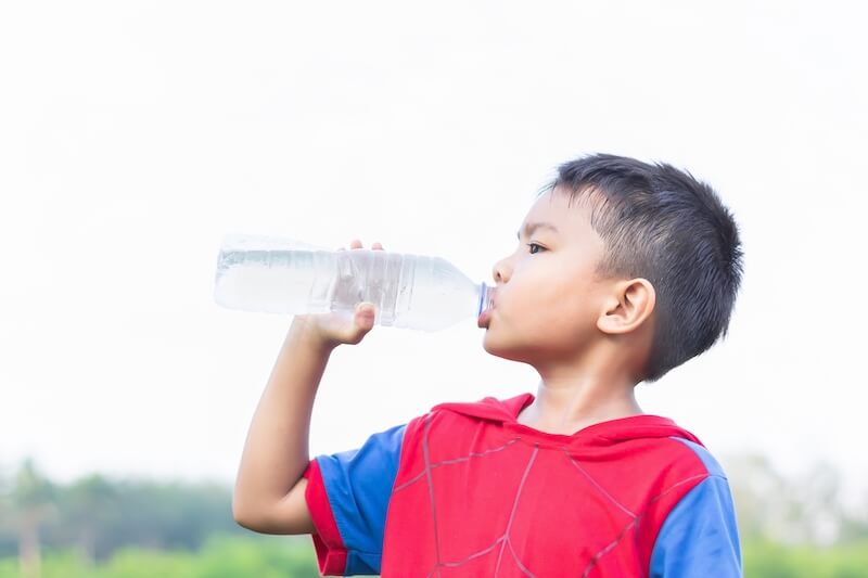 Ho, every one that thirsteth, come ye to the waters showing a thirsty child drinking from a bottle