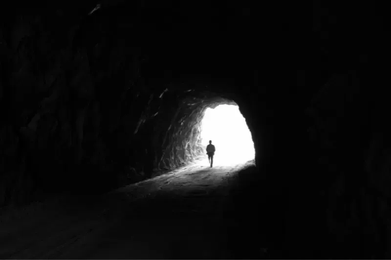 Satan exposed light of the word showing a man coming out of a cave