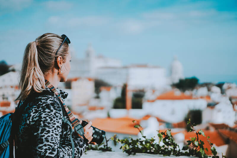 be not conformed to the world showing a woman looking at a city