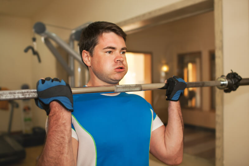 be strong showing a man lifting up weights