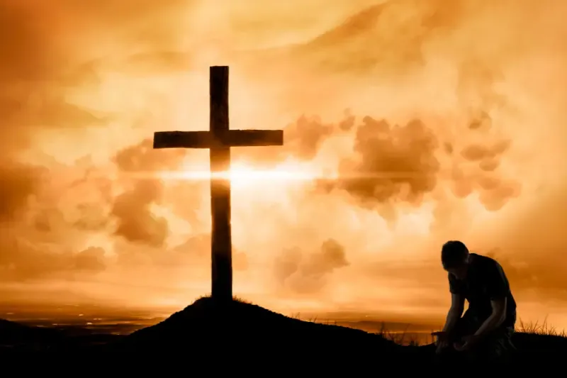 The blood is in the Word, showing a man kneeling at the cross
