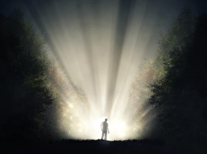Christ the Power of God, and the Wisdom of God showing a man with light in the forest