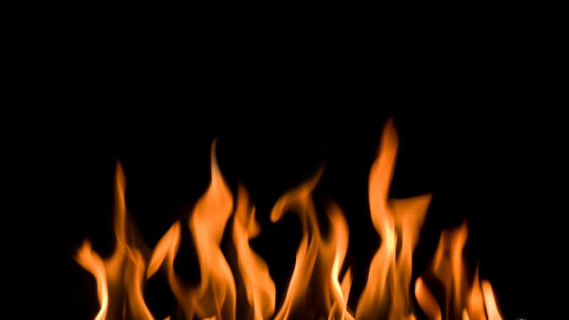 Tongues of fire image showing flames of fire burning in a dark background