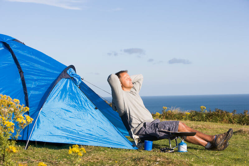 Enlarge the place of thy tent and showing a man camping outdoors