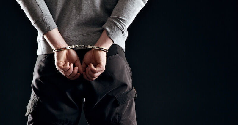 Forgiveness showing a man in handcuffs behind him