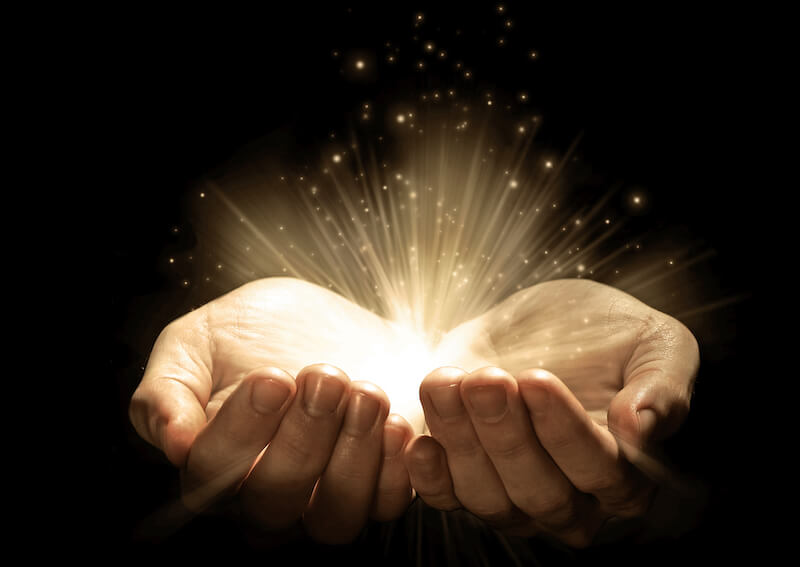 special miracles by the hands of Paul showing two hands holding a glow