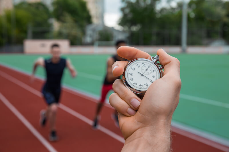 He that hath begun a good work in you showing athletes in a race and a stock watch