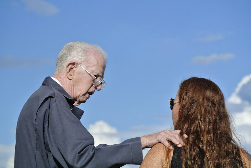 he that winneth souls is wise showing an elderly man talking to a woman