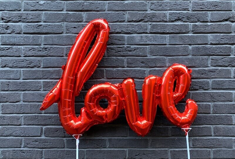 his banner over me was love showing the word love in balloons