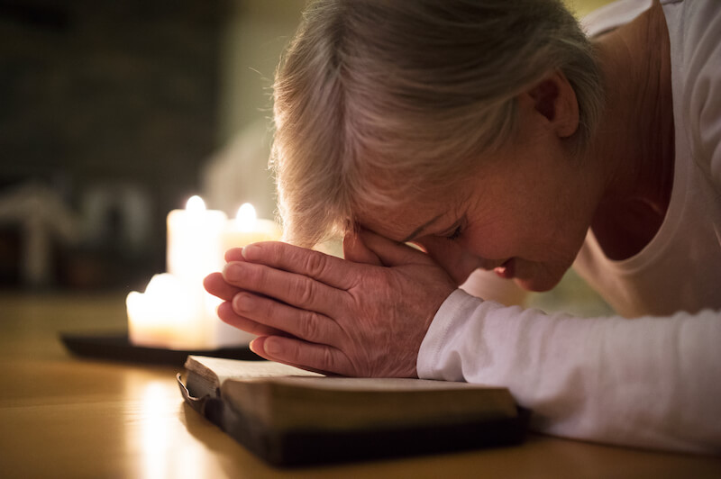 The hour of prayer is a time of fellowship showing a woman praying