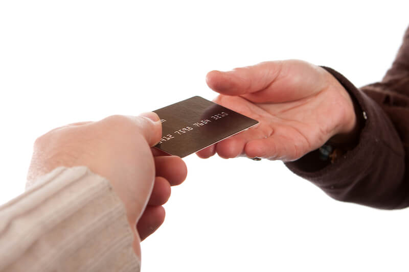 imputed righteousness showing a man handed a bank card to another