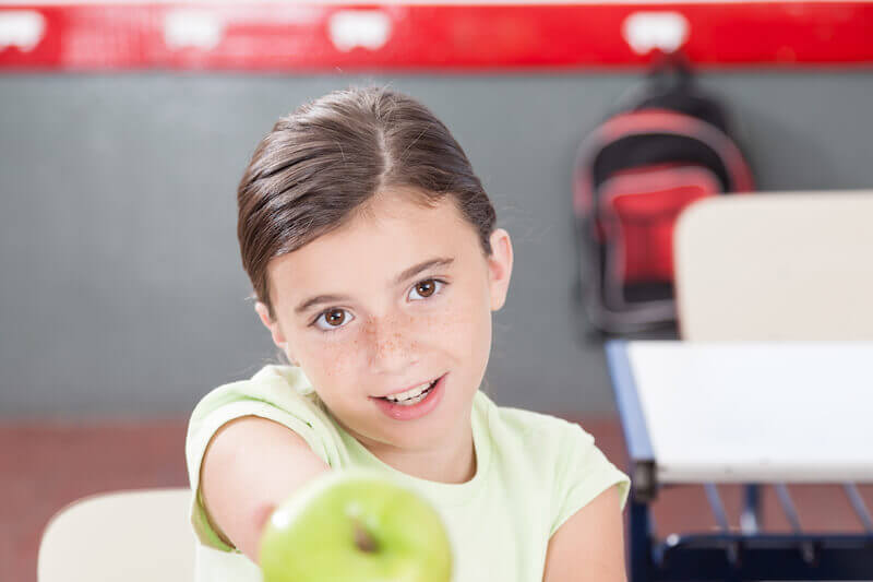 Love is kind showing a girl sharing an apple
