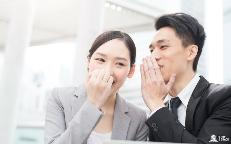 Power of words showing a man and a woman whispering to each other