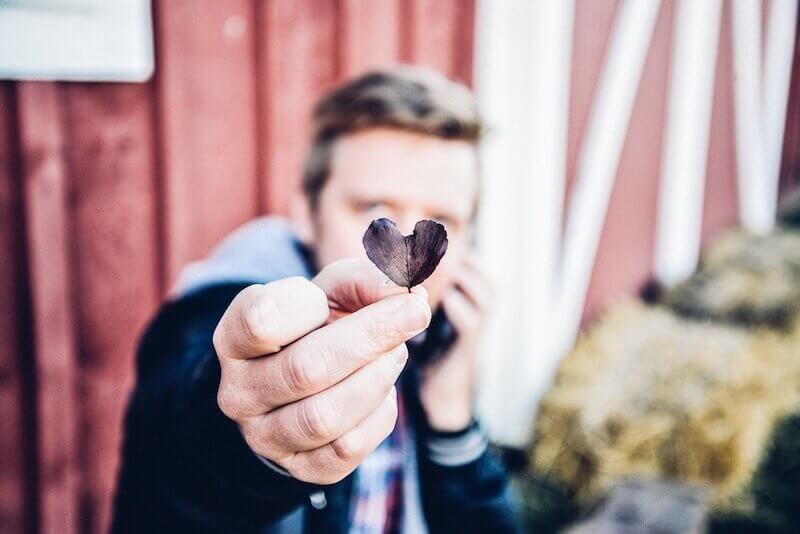 my son give me your heart showing a young man giving a heart shaped leaf