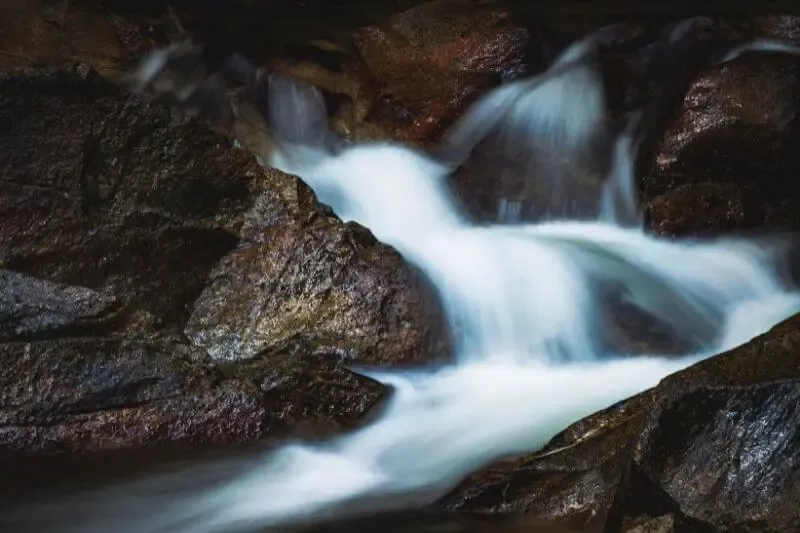 Outpouring as outflowing showing rivers flowing down a rock