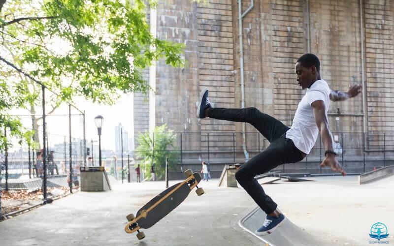 Pride goes before a fall showing a young man falling off his roller board