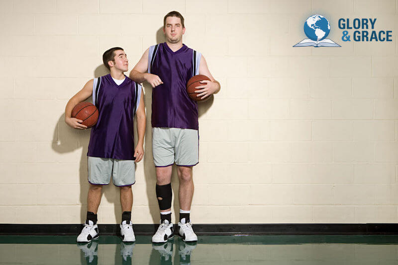 Shortest book in the Bible image showing two men standing side by side with one significantly taller than the other