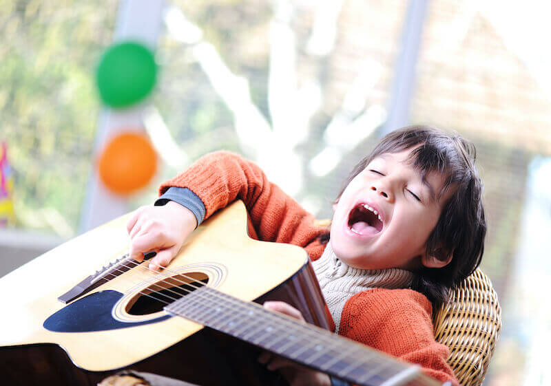 sing a new song unto the Lord showing child with a guitar