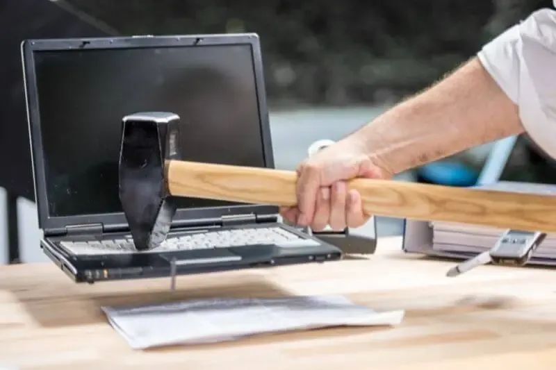 destroy the works of the devil showing a man smashing a laptop