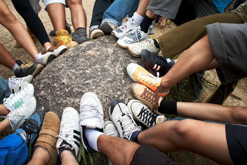 Spiritual strength showing a group of people smashing a stone