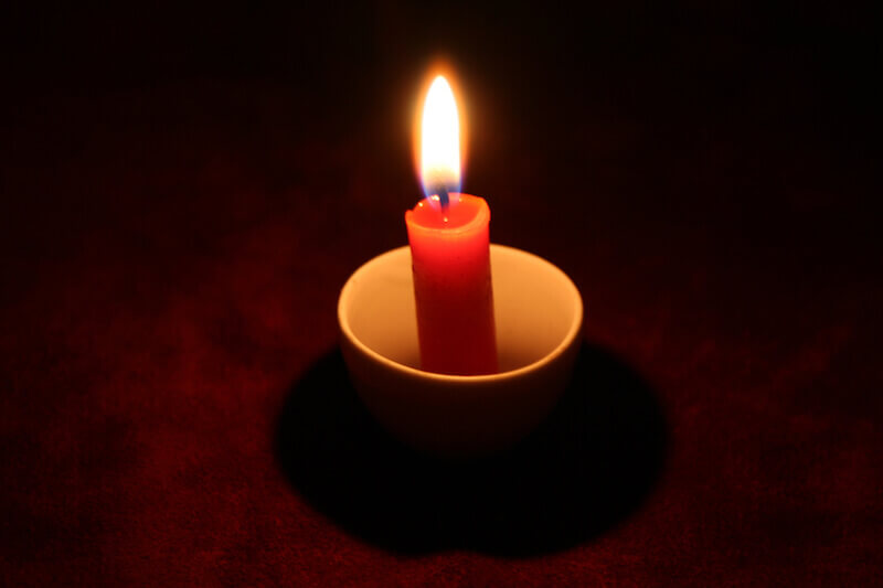 Thou wilt light my candle showing a candle in the dark