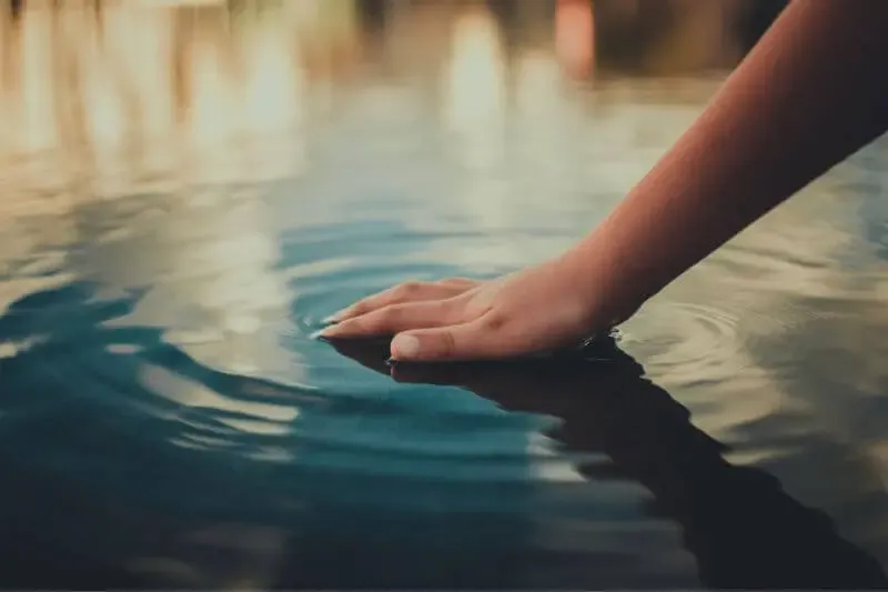 who touched me showing a hand touching water