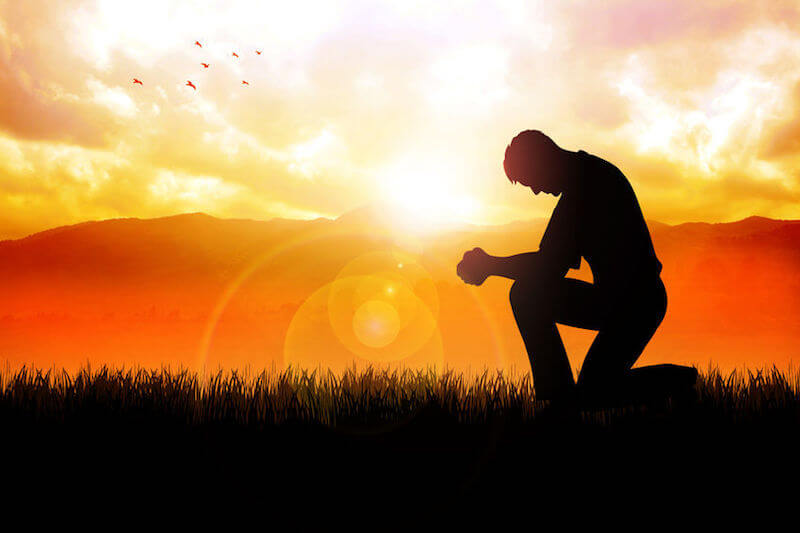 Yielding to God in everyday life. A man praying, surrendered to God.
