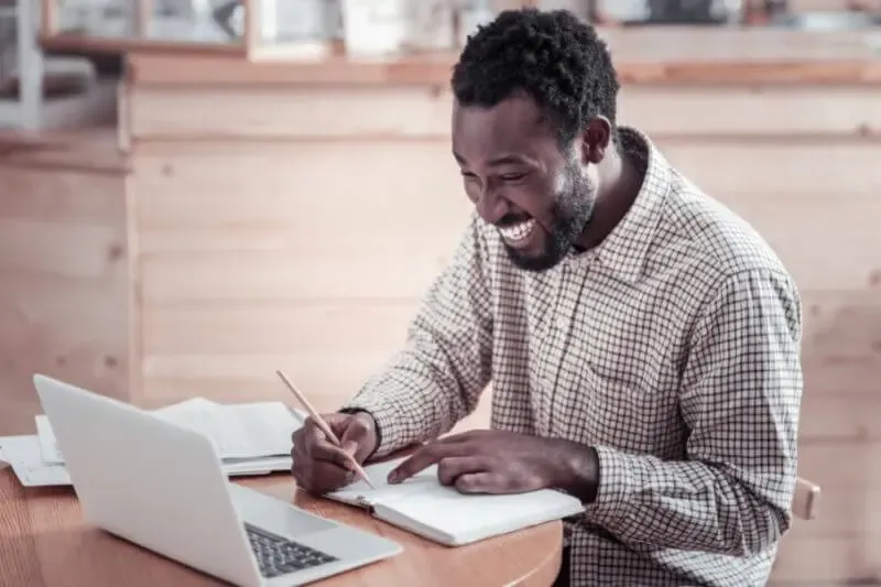 testimonies our delight showing a a happy man looking at his computer