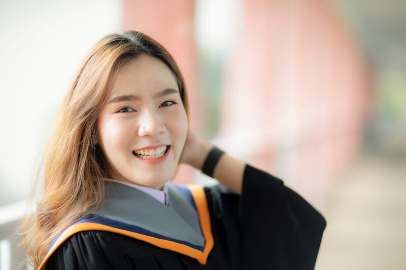 clothed with power from on high showing an asian woman dressed in graduation robe