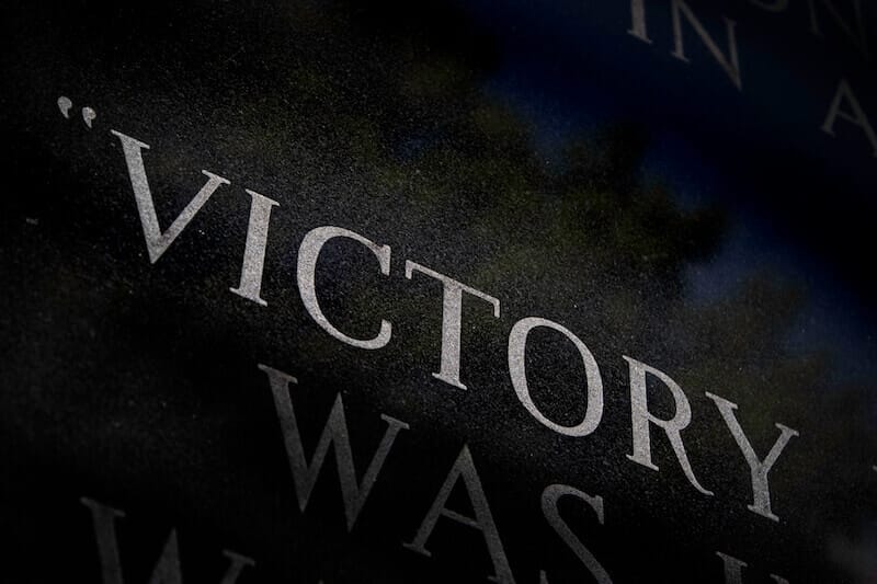 victory showing the letters of the word in a dark background