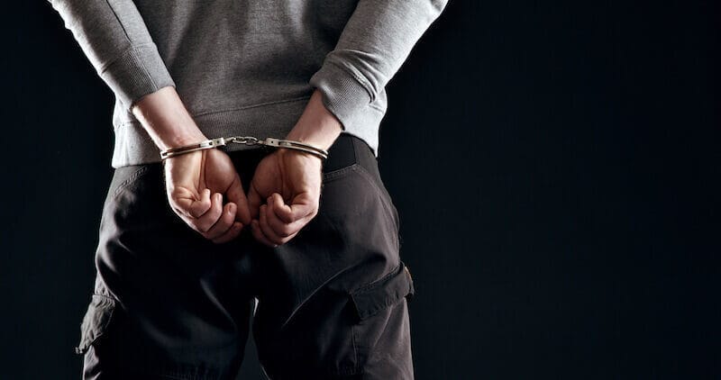 Forgiveness showing a man in handcuffs behind him
