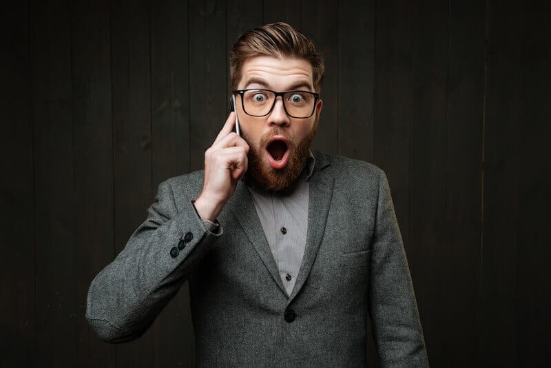 God manifested in the flesh showing a man on the phone hearing something surprising