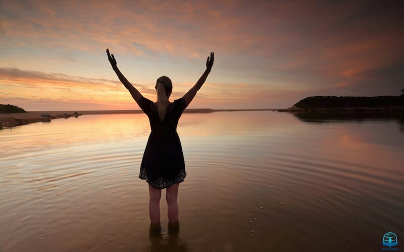 What is happening to worship? Image sowing a woman with lifted hands in water