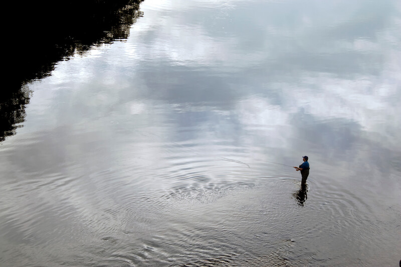 Jesus sent Peter back showing a man fishing in a river
