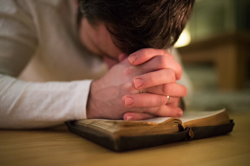 Lord teach us to pray showing a man praying