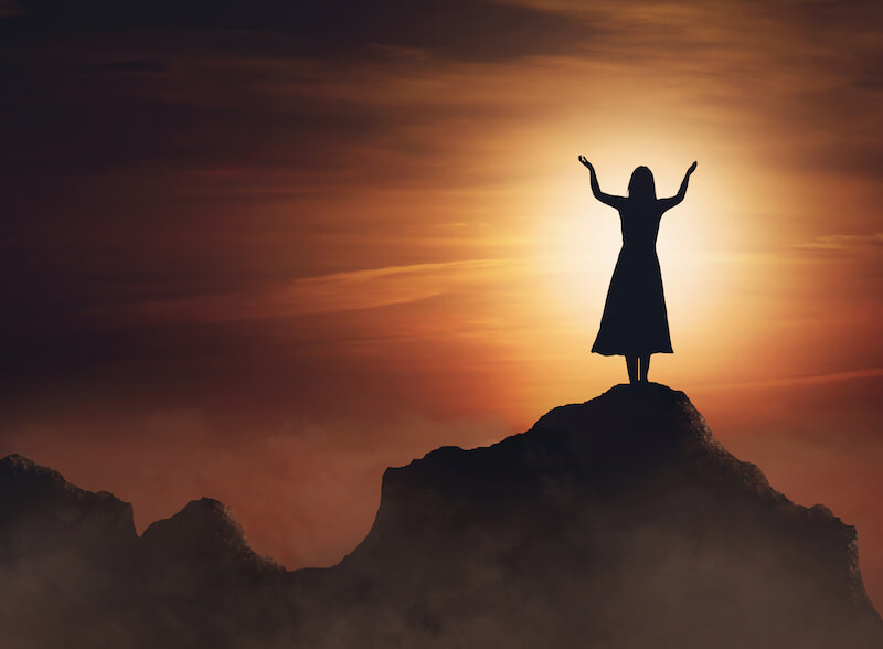 be of good cheer showing a woman on a mountain