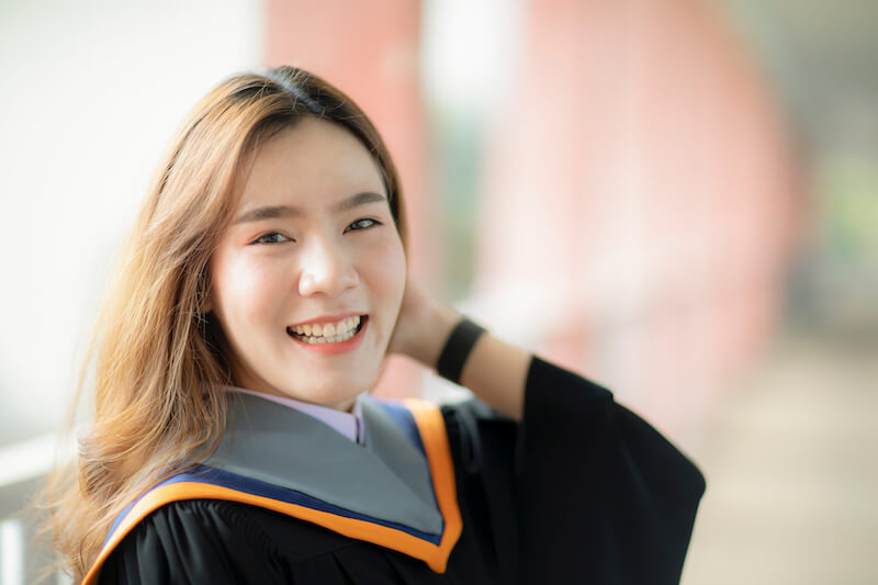 clothed with power from on high showing an asian woman dressed in graduation robe