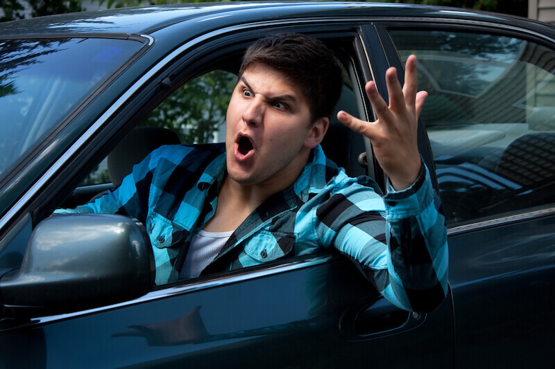 fool gives full vent to his anger showing a man on the road