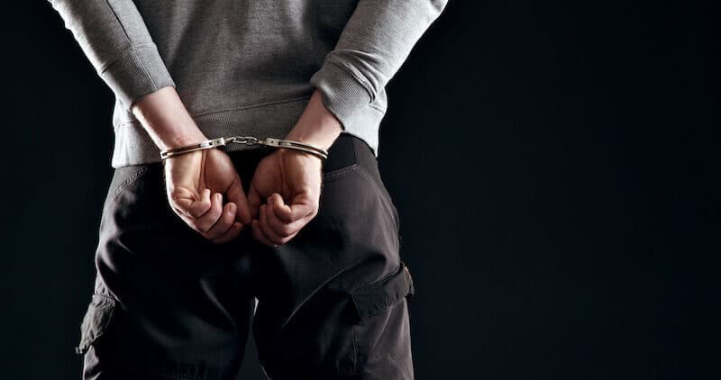 Forgiveness showing a man in handcuffs behind him