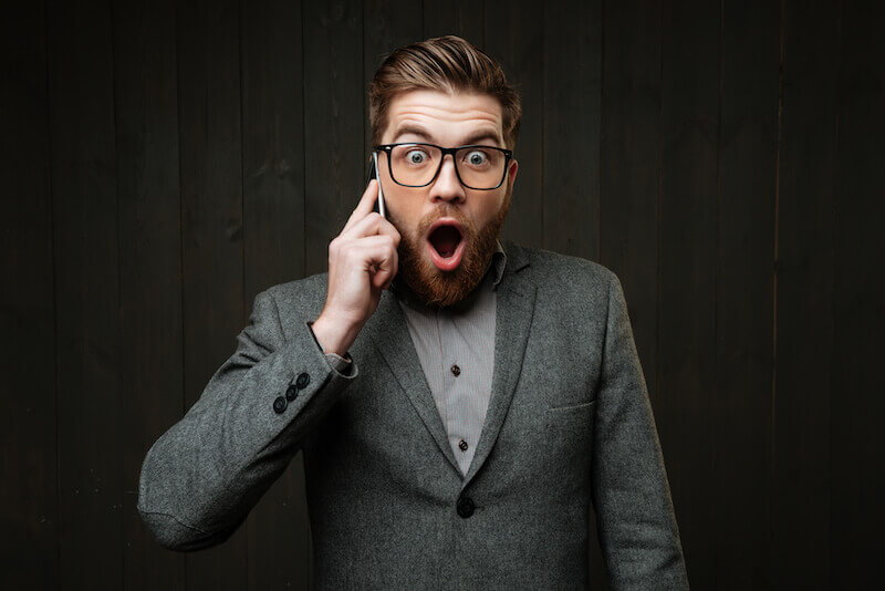 God manifested in the flesh showing a man on the phone hearing something surprising