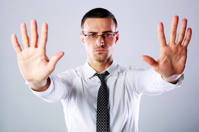 is grace a license to sin? showing a man with two hands up to back off