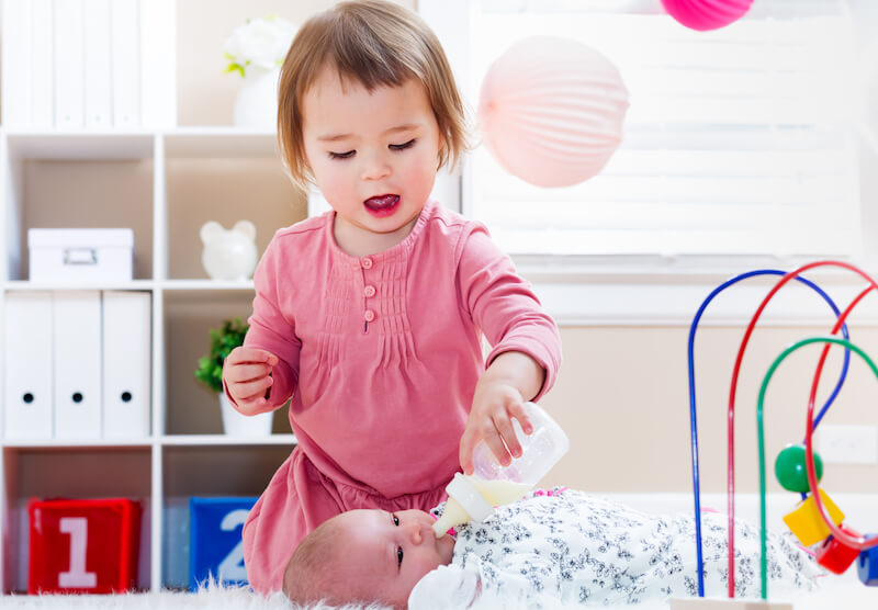 as newborn babies desire the sincere mild showing a toddler feeding her baby sister