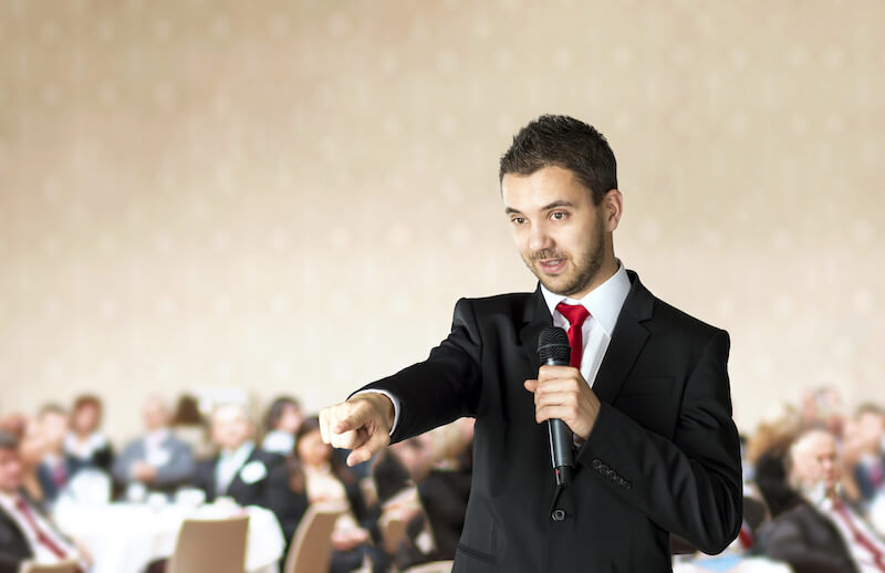 motivational speaker talking to a crowd
