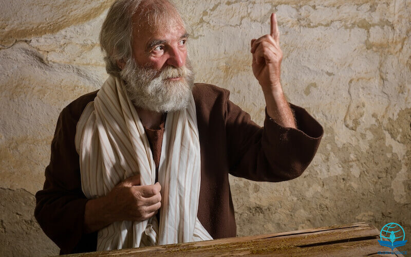 Prophesy unto these bones image showing a prophet with his hands up