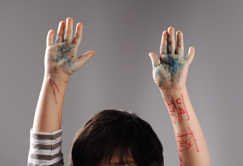 dying to self showing a girls hands up