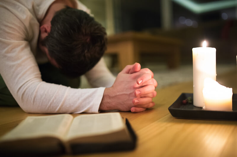thy prayer is heard showing a man praying