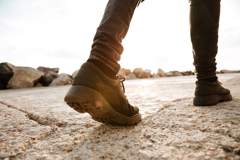 walking in the flesh and Spirit showing the boots of a man walking