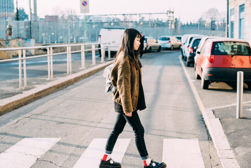 paths of life showing a woman crossing the road