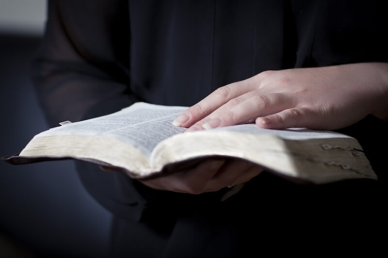 what is truth showing hands holding and opening the Bible
