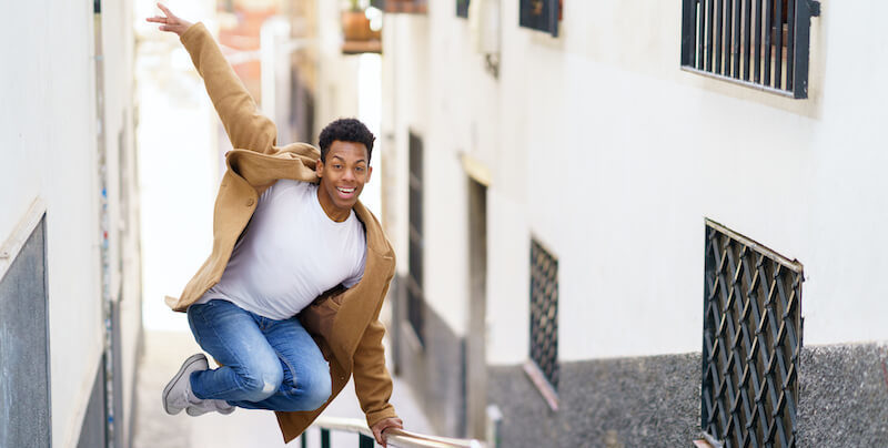A merry heart maketh a cheerful countenance showing a young man jumping up in joy